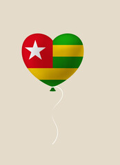 Togolese flag heart-shaped balloon floating as a symbol of love and pride for a national holiday celebration.