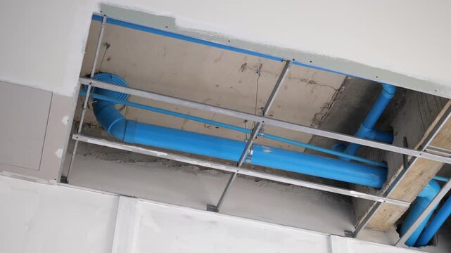 Blue PVC Plumbing Pipes Installed in Ceiling During Building Construction