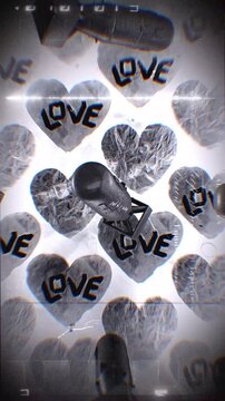A looping background of stop motion style grungy paper love hearts with multiple spinning atom bombs.