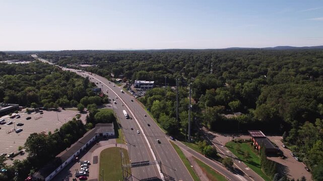 Drone aerial shot of NJ-17 interstate 17 highway and multi-lane road way in New Jersey with car traffic heading towards New York City NYC in American Atlantic East Coast roadway landscape in tri-state
