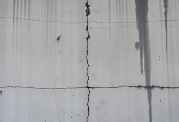 Weathered concrete wall with dark stains and rough texture, conveying a raw, aged, and distressed urban aesthetic,  atmospheric,  aged