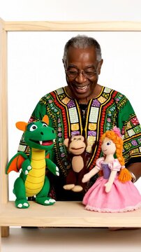 Elderly Man in Dashiki Performs Puppet Show With Dragon Princess and Monkey Toys