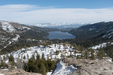 Scenic view of Donner Lake in the Sierra Nevada mountains of California, featuring clear blue water, forested shoreline, and surrounding alpine peaks. A peaceful natural landscape ideal for travel, ou