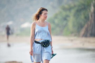 young woman walking on the beach