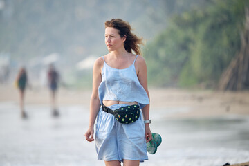 young woman standing on the beach