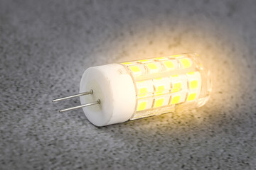 a led light bulb on a concrete background.