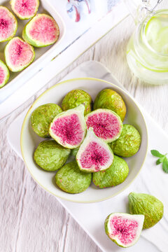 Fresh Pink Figs in Bowl on White Wooden Table