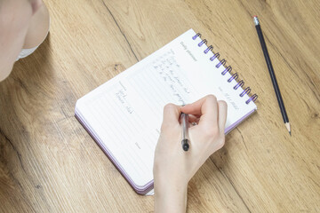 Writing in Daily Planner at Home