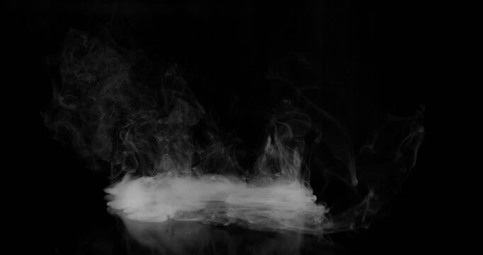 Super Slow Motion of White Surface Smoke Texture Isolated on Black Background. Filmed on High Speed Cinema Camera, 500fps. VFX element for overlay.