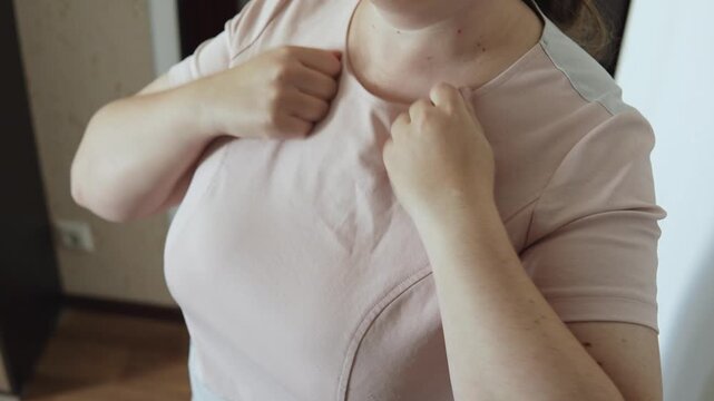 Woman lightly tapping collarbone with fists, close-up. Female figure activating lymphatic system, relieve tension and releasing muscle strain during self-massage at home.