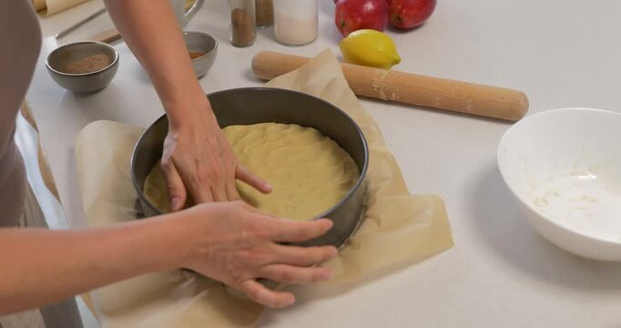 Woman forming shortbread dough in springform pan
