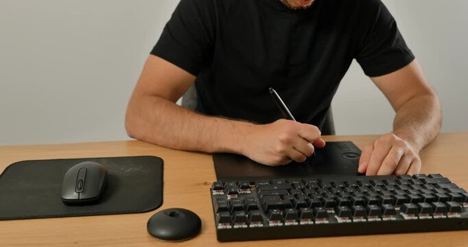 Close-up of man using wireless mouse and mechanical keyboard on desk