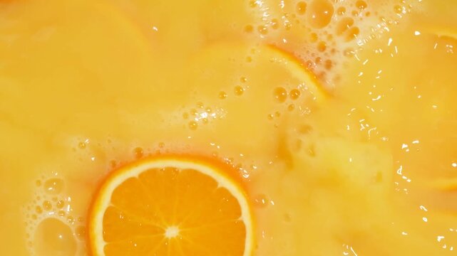 Refreshing orange juice explosion with falling fruit slices