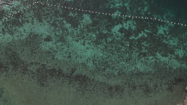 Top view of turquoise water and coming to a view of a boat in Samal island