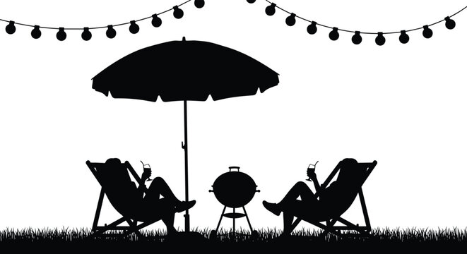 Silhouette of a happy couple relaxing in deck chairs with drinks under a patio umbrella by a barbecue grill at sunset