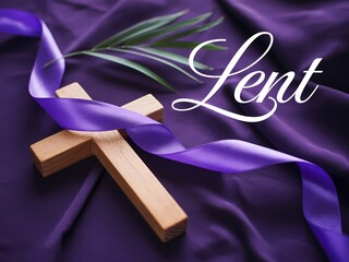 A wooden cross with a purple ribbon and palm branch on purple fabric for lent