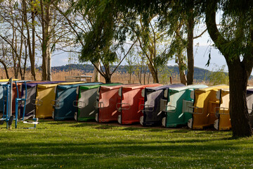 Colorful pedal boats line the shore, ready for a fun day on the lake.