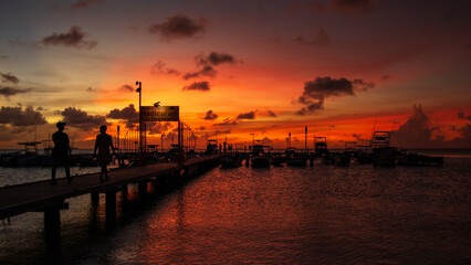 Dramatic Sunset Silhouette at Hadicurari Fishing Pier with Boats and Walkers - Marriott Surf Club Aruba, Palm Beach Caribbean Tropical Seascape