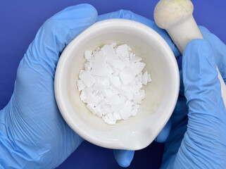 Potassium hydroxide KOH, and is commonly called caustic potash.