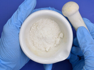 Sodium diethyldithiocarbamate powder on the light gray background