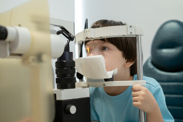 Optometry concept. An optometrist checks a boy's vision in an ophthalmology clinic.