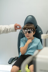An ophthalmologist examines a little boy using modern equipment