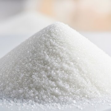 A large, brightly lit pile of pure white granulated sugar crystals, useful for baking, cooking, and adding sweetness to food, dessert, food, close-up
