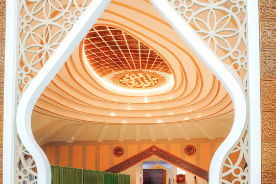 Indonesia, Central Java, November 16, 2025: Modern Islamic mosque with elegant geometric architecture, white walls decorated with gray stone, and beautiful but detailed gold lattice windows