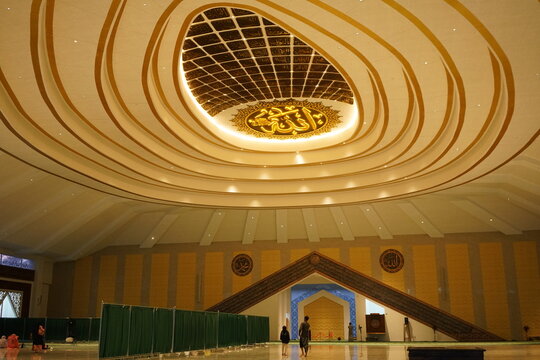 Indonesia, Central Java, November 16, 2025: Modern Islamic mosque with elegant geometric architecture, white walls decorated with gray stone, and beautiful but detailed gold lattice windows