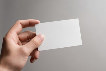 Fototapeta premium Blank White Leaflet Mock up Held in Hand for Creative Design and Marketing Projects in High Resolution Format