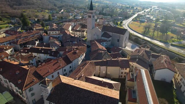 Cinematic Aerial View of Venzone del Friuli: Medieval Walled City, Duomo di Sant'Andrea Apostolo and Julian Alps Mountain Backdrop, Udine Friuli Italy 4K