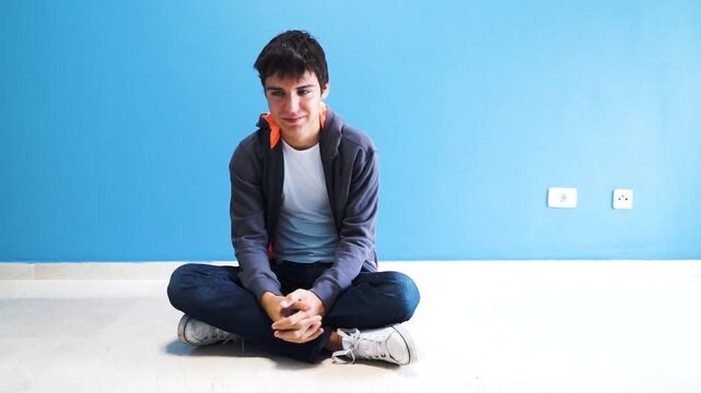 international autism awareness day- young man sitting with his back to camera, brain disoders, autism and depression concept