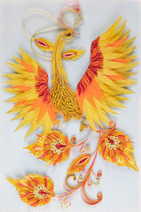Obraz premium Colored paper firebird in a frame isolated on a white background