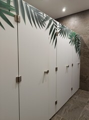 lockers in the locker room for personal items, sports locker room, public toilet cubicles
