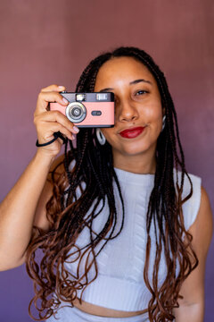 A woman holding an analog camera