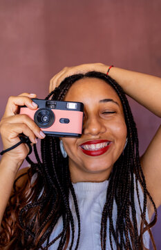 A woman holding an analog camera