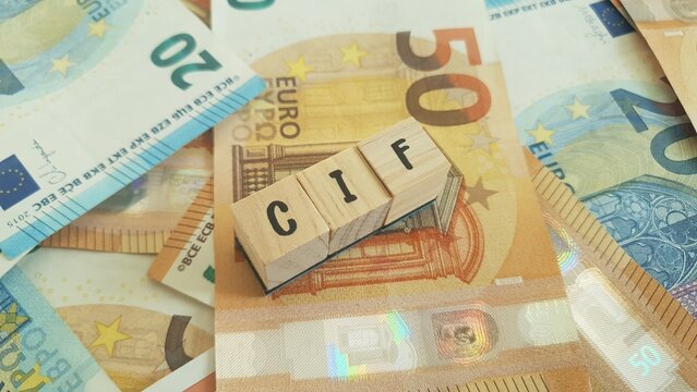 CIF acronym made of wooden letter cubes on pile of Euro banknotes. Collective Investment Fund