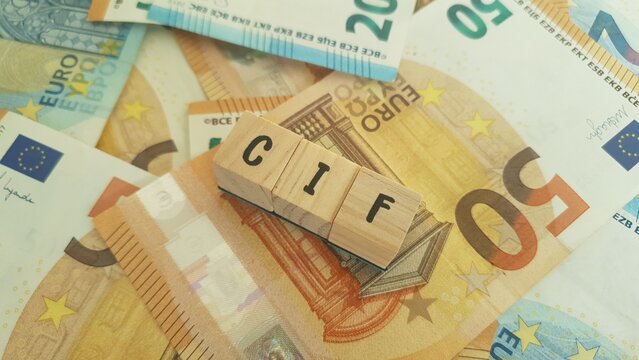 CIF acronym made of wooden letter cubes on pile of Euro banknotes. Collective Investment Fund