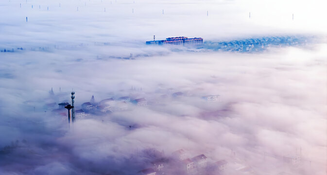 City Skyline Emerging from Clouds at Dawn