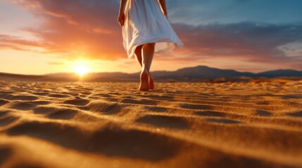 A serene moment captured as a woman walks barefoot across a sandy desert landscape, evoking feelings of freedom, connection to nature, and the beauty of solitude at sunset.