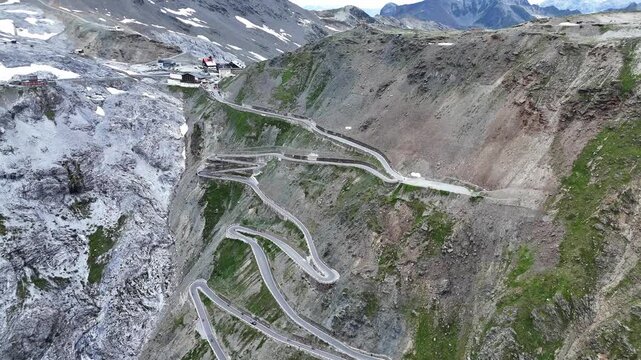 Stelvio Pass, Italy - July 07 2025: Aerial view of the pass. Hairpins, mountain pass, mountain road. Travel, tourism. Motorcycle, car.