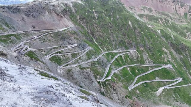 Stelvio Pass, Italy - July 07 2025: Aerial view of the pass. Hairpins, mountain pass, mountain road. Travel, tourism. Motorcycle, car.