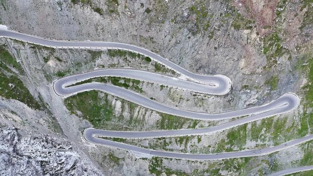 Stelvio Pass, Italy - July 07 2025: Aerial view of the pass. Hairpins, mountain pass, mountain road. Travel, tourism. Motorcycle, car.