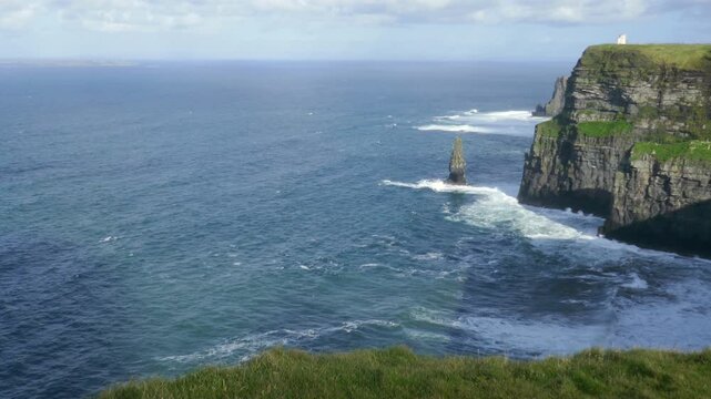 The famous Cliffs of Moher, tourist viewing location of spectacular sea cliffs in the Burren region of County Clare, Ireland. O'Brien's Tower visible and passing clouds casting a shadow.