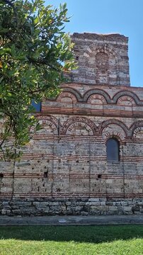 Nessebar, Bulgaria - August 25, 2025: Church of Christ Pantocrator. Fragment of the facade of a medieval Orthodox church. Late Byzantine style. Facade with colorful decor, ceramic elements