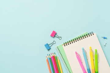 Fototapeta premium School supplies or office stationery on blue background.