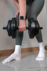 Naklejka premium Home gym workout, woman lifting dumbbells on mat in bright living room, strength training, functional fitness, wellness routine, active lifestyle,