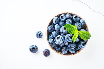 Blueberries in the bowl on white.