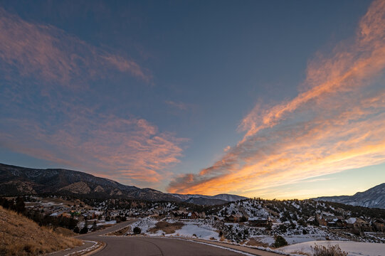 Colorful orange and blue winter sunrise cloudscape over New Castle in western Colorado.