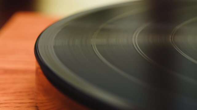 Retro Vinyl record player playing music, needle close-up macro shot of vintage LP disc old phonograph spinning. Retro music player at home.